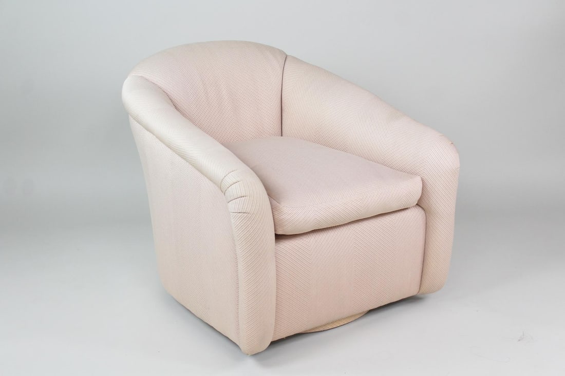 Pale Pink Milo Baughman Style Tub Chair: Mid Century Modern Pale Pink Milo Baughman Style Tub Chair. The chair swivel on a circular raised platform base. No makers mark. Dimensions are 36 in h x 31.75 in w x 36.5 in d. Seat rise is 18 in h.