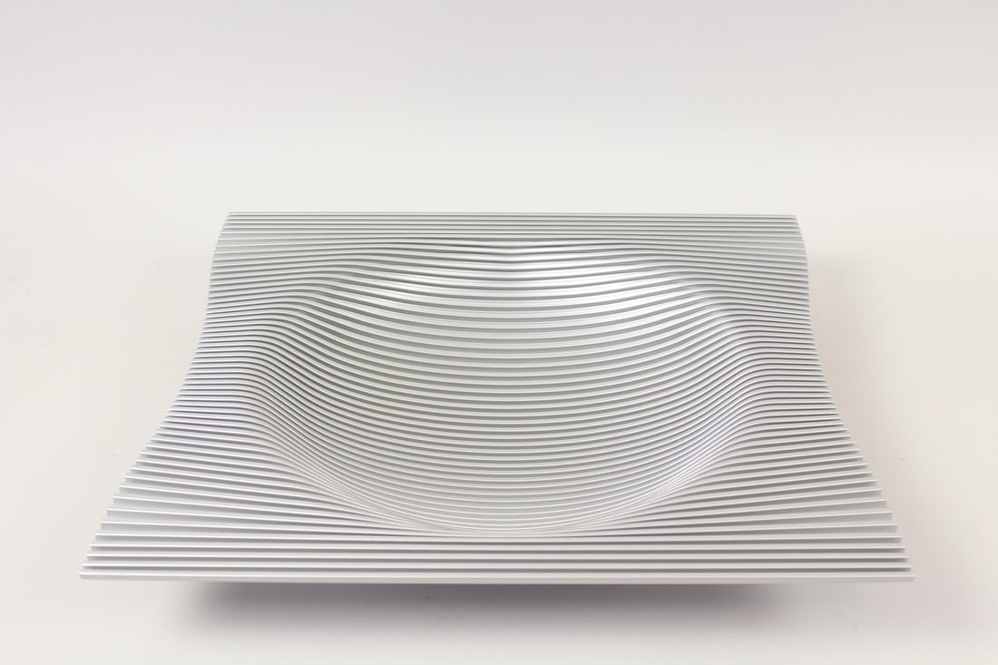 Christoph Boninger Corrugated Aluminum Bowl: Christoph Boninger Modernist Op Art Corrugated Aluminum Bowl. Large centerpiece or fruit bowl made of a single sheet of aluminum. Dimensions are 2.5 in h x 17.75 in w x 15 in d. Condition is good with