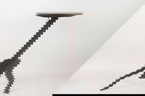 Primitive Painted Black Tilt Top Candle Stand: Primitive Painted Black Tilt Top Wooden Table with Sculptural Legs. Unusual table with tilt top and 3 legs cut in a curved shape, reinforced with metal. Nice patina. Dimensions are 28 in h x 21.5 in w