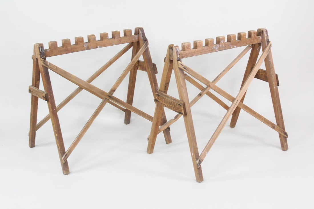 Pair of Teeth Top Wooden Saw Horses for Table: Pair of Industrial Primitive Wooden Saw Horses for Table. Matching pair of sawhorses with grooves cut into the top bar, could be used as a table base. Dimensions are 31.5 in h x 21 in w x 31 in d. Con