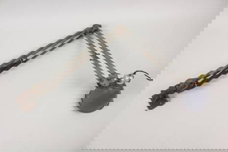 Industrial Wall Mount Drafting Lamp: Industrial Wall Mount Drafting Lamp. This metal light has jointed angles to specify the height and direction of the spotlight shade. It has a bracket that can screw into the wall or the side of a work