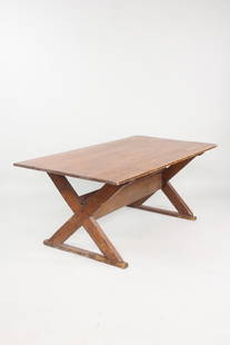 Primitive Pine Sawbuck Trestle Farm Table: Primitive Pine Trestle Farm Table with X Base. Table features a knotty pine top and trestle X shaped base. Dimensions are 27.75 in h x 69 in w x 35.5 in d. Condition is good with heavy wear to the top