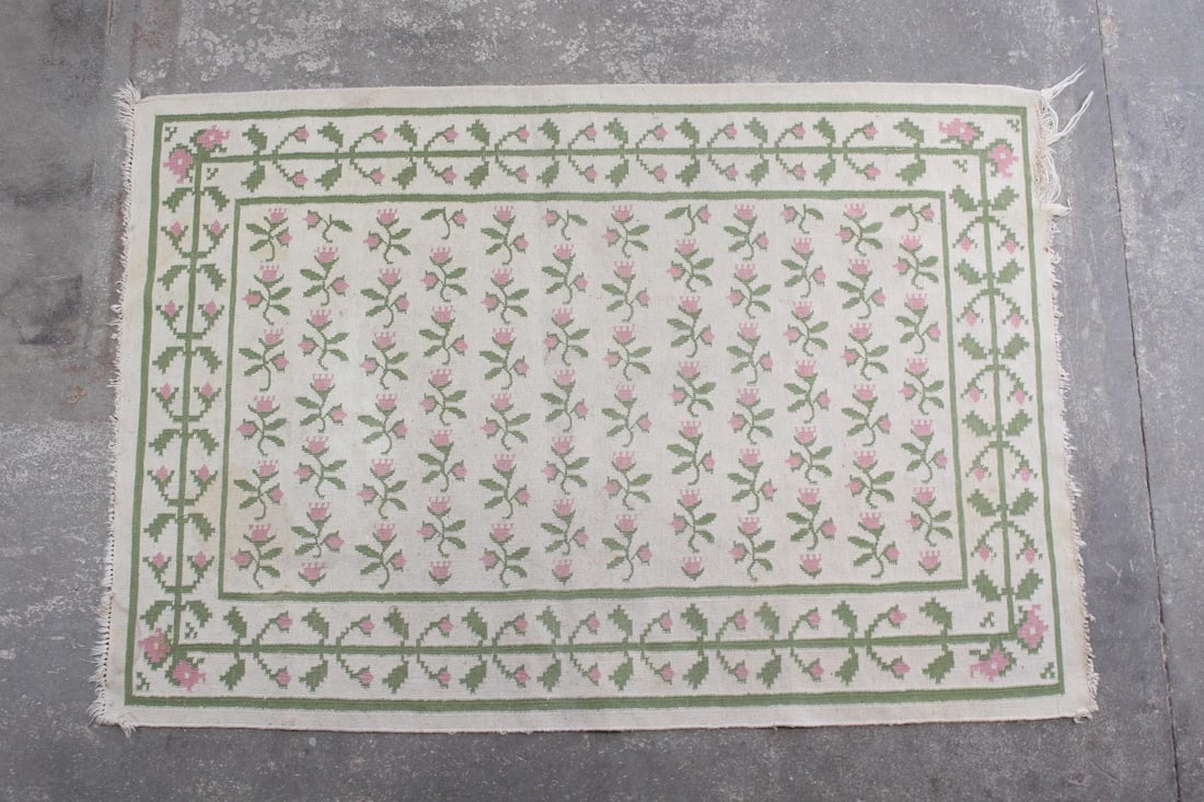 Dhurrie Rug with Pink & Green Flowers, 6x4 Ft: 6x4 Ft Dhurrie Rug with Pink & Green Flowers. Wool flat weave rug with an off-white ground, with a border and center filled with pink and green flowers. Dimensions are 72 in h x 49 in w x .25 in d. Co