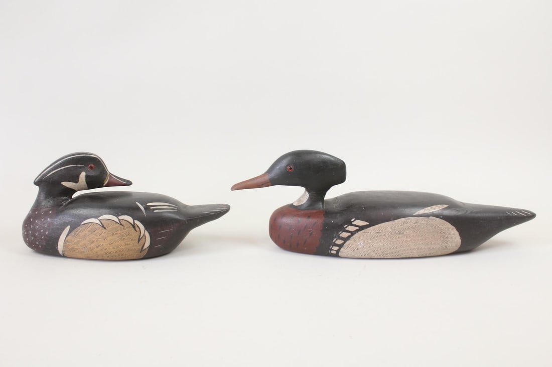 Pair of Duck Decoys, Charles Moore, 1973: Pair of Duck Decoys, Charles Moore, 1973. Sculptural pair, one looks ahead while the other turns its head backward. Carved & hand painted with black, white, brown, and rust hues. Possibly with glass e