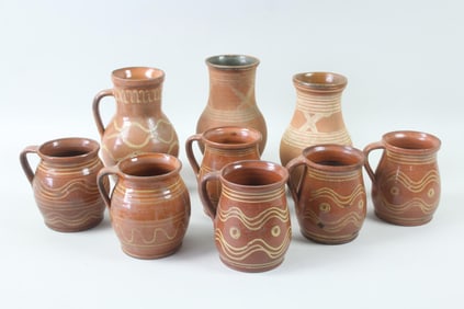 Group of 9 Redware Slip Decorated Pitchers