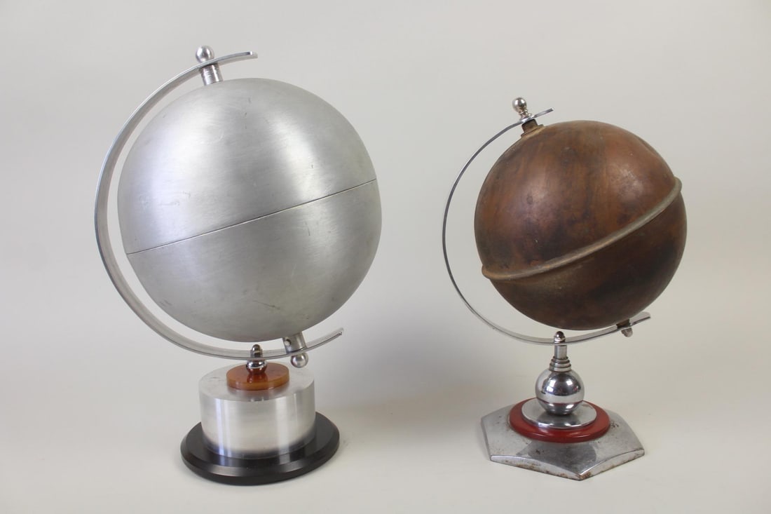 Lot of 2 Art Deco Style Metal & Bakelite Globe Sculptures: Lot of 2 Art Deco Style Metal & Bakelite Globes. Two mixed metal globe decorative objects, one with an aluminum globe and the other copper, with chrome finish and bakelite details. Dimensions are 14 i