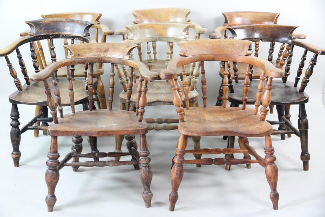 Lot of 8 Tavern Chairs, Various Wood Colors, 1 of 2: Lot of 8 Captain's Chairs in Various Wood Colors, 1 of 2. This group of eight chairs have the same form and different tones of wood. They feature a classic barrel back or "smoker's bow" shape with spi