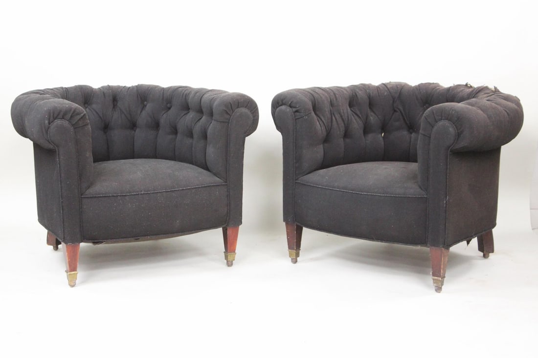 Pair of Black Chesterfield Club Chairs: Pair of Black Chesterfield Lounge Club Chairs. Barrel back structure with tufted black fabric upholstery and wooden legs with metal caps. Dimensions are 27.25 in h x 36.5 in w x 34 in d. Seat rise is