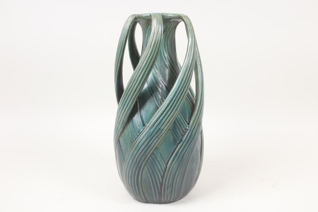 Arts & Crafts Green Twisted Iris Leaf Vase: Arts & Crafts Green Twisted Iris Leaf Vase. Similar to a design by Teco, but unmarked. Dimensions are 13.5 in h x 6.5 in w x 6.5 in d. Condition is good with minor surface wear . Please call or email