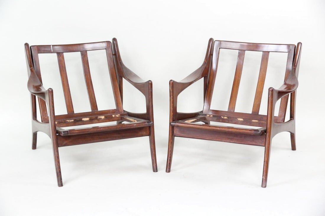 Danish Modern Sculpted Lounge Chairs: Dutch Mid-century Modern Lounge Chairs. Beautiful, sculptural frames with curved arms, slatted backs, and angled legs. Made of deep, rich wood, possibly teak. Unmarked, possibly designed by De Ster Ge