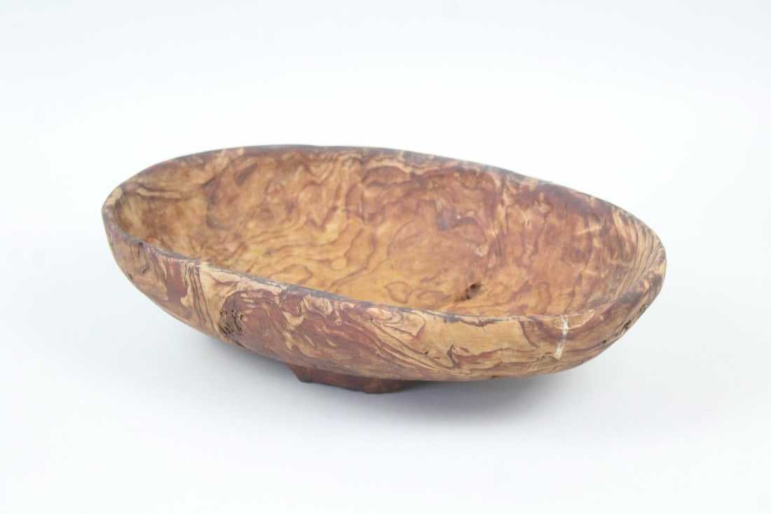 Primitive Figured Wood Carved Bowl: Primitive Folk Art Figured Wood Carved Bowl. Unusual egg shaped carved bowl is made of warm tone figured wood (possibly olive,) with textured exterior and on 3 feet. Dimensions are 3.75 in h x 13.5 in