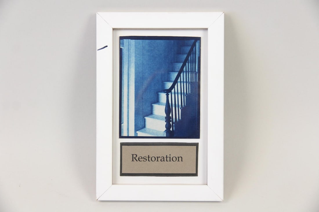 Cyanotype by John Patrick Dugdale, Hudson Valley Restoration: Cyanotype by John Patrick Dugdale, Staircase, 1999. A photograph of a staircase with a dark banister, it has a distinctive blue tone characteristic of the cyanotype process. Mounted in a white frame w