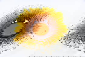 Revontulet Northern Lights Art Glass Bowl by Tauno Wirkkala for Humppila: Mid-Century Modern Glass Bowl by Tauno Wirkkala for Humppila. A shallow, sculptural bowl with jagged texture in glistening hues of amber colored glass. Designed by Finnish designer Tauno Wirkkala for