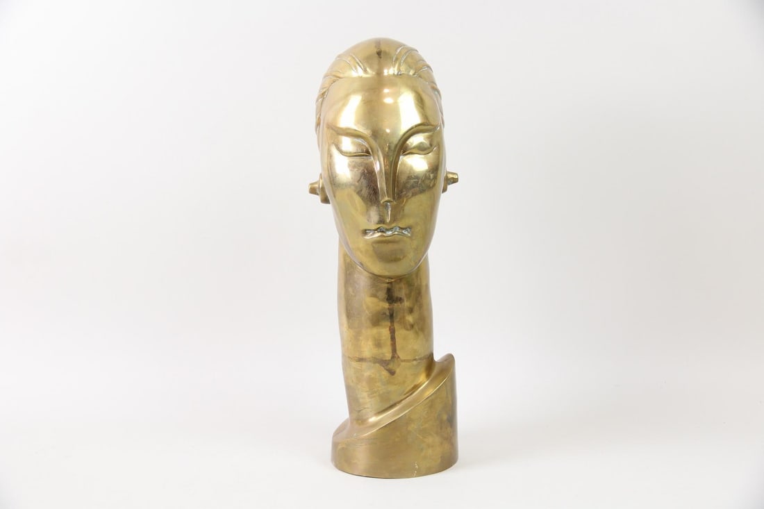 Modernist Brass Female Bust, Franz Hagenauer: Modernist Art Deco Streamline Brass Female Bust, Manner of Franz Hagenauer. Bust of a woman in brass, with futuristic styling and elongated neck. Dimensions are 17 in h x 5.5 in w x 7 in d. Condition