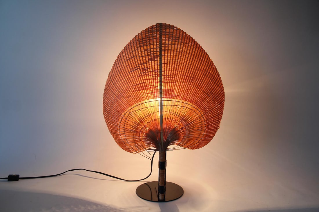 Uchiwa Wicker Fan Lamp, Ingo Maurer: Mid-Century Modern Ingo Maurer "Uchiwa" Wicker Fan Lamp. Inspired by traditional Japanese Uchiwa fans, with black metal base. Unmarked. Dimensions are 20 in h x 14.5 in w x 6 in d. Condition is good w