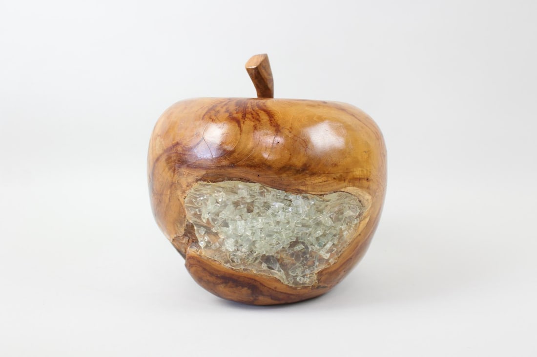 Carved Burl Sculpture, Apple with Plastic Crystal: Oversized Apple Sculpture with Glass Crystal. A decorative apple sculpture made of warm wood with two sections filled with clear, crushed and melted plastic or resin. Dimensions are 11.5 in h x 10.5 i