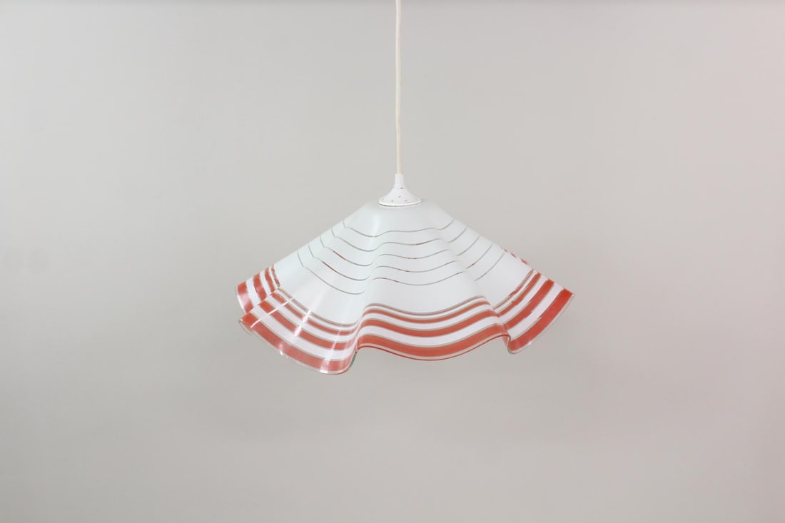 Red & White Handkerchief Glass Pendant Lamp: Mid-century Modern Red & White Handkerchief Glass Pendant Lamp. Hanging light fixture with white folded glass shade and red stripes, possibly Murano. Dimensions are 9.5 in h x 19.5 in w x 19.5 in d. C