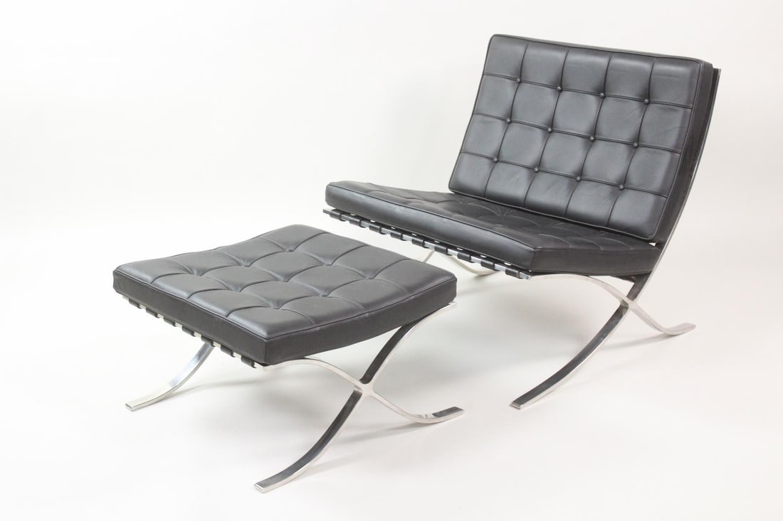 Contemporary Black Barcelona Chair and Ottoman: Contemporary Black Leather Barcelona Chair and Ottoman, originally designed by Mies Van de Rohe. Steel bar construction with faux leather cushions. This is a contemporary version of this chair and ott