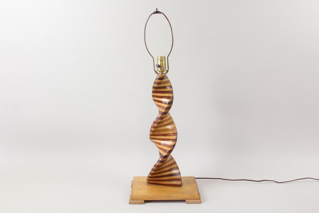 Sculptural Wooden Spinner Table Lamp, Folk Art: Mid-Century Modern Twisted Spiral Lamp. A sculptural lamp with helix-shaped wooden base, crafted from alternating light and dark wood strips. Marked "S. Church" on the bottom. Dimensions are 28 in h x