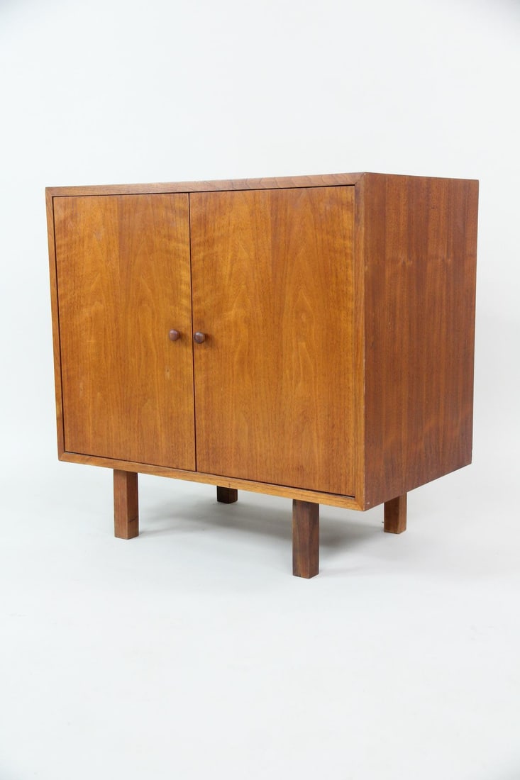Minimalist 2-Door Wooden Cabinet: Mid-Century Modern 2-Door Wooden Cabinet. A simple cabinet with two doors, round wooden knobs, and four short legs. The interior has two shelves. Dimensions are 28.5 in h x 30 in w x 18 in d. Conditio
