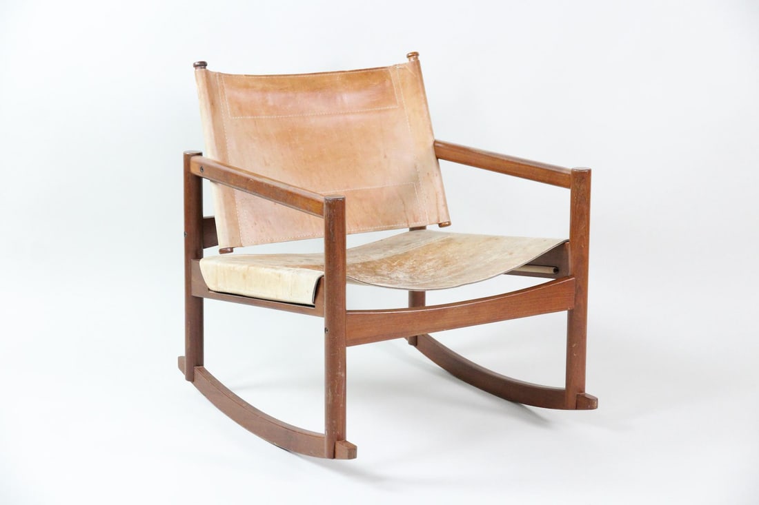 Michel Arnoult Peglev Wood & Leather Sling Rocker: Mid-Century Modern Michel Arnoult Sling Rocker. A low profile rocking chair with tan leather sling seat and dark wood frame, possibly rosewood or walnut. Lovely patina to leather. Unmarked, we believe