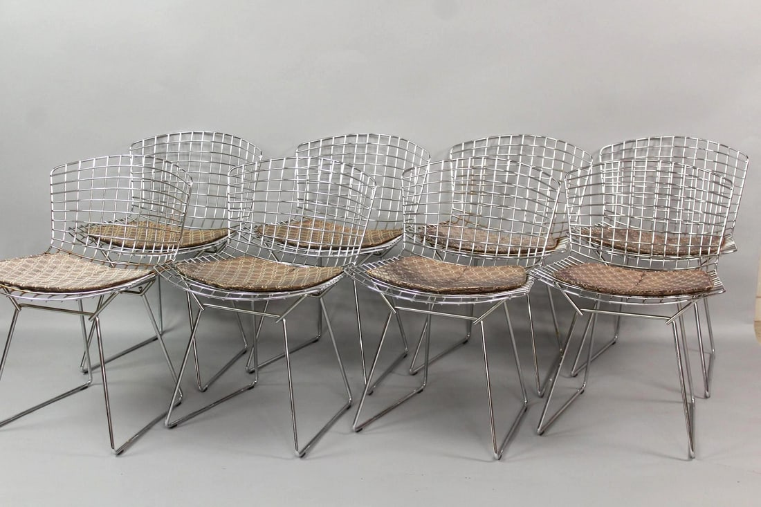 Set of 8 Knoll Bertoia Side Chairs: Set of 8 Mid-Century Modern Harry Bertoia Side Chairs.Matching set of chairs with silver finish and red, yellow and black cushions with a circular motif. This set has surface rust to the chrome, still
