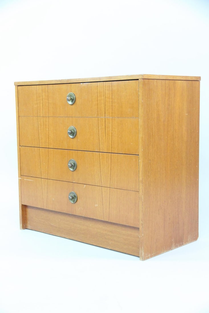 Diminutive 4-Drawer Wooden Dresser, Chest of Drawers: Mid-Century Modern 4-Drawer Dresser. A simple chest of drawers that has warm wood veneer and small metal pulls. Dimensions are 22 in h x 24 in w x 13 in d. Condition is good with some scuffs and scrat