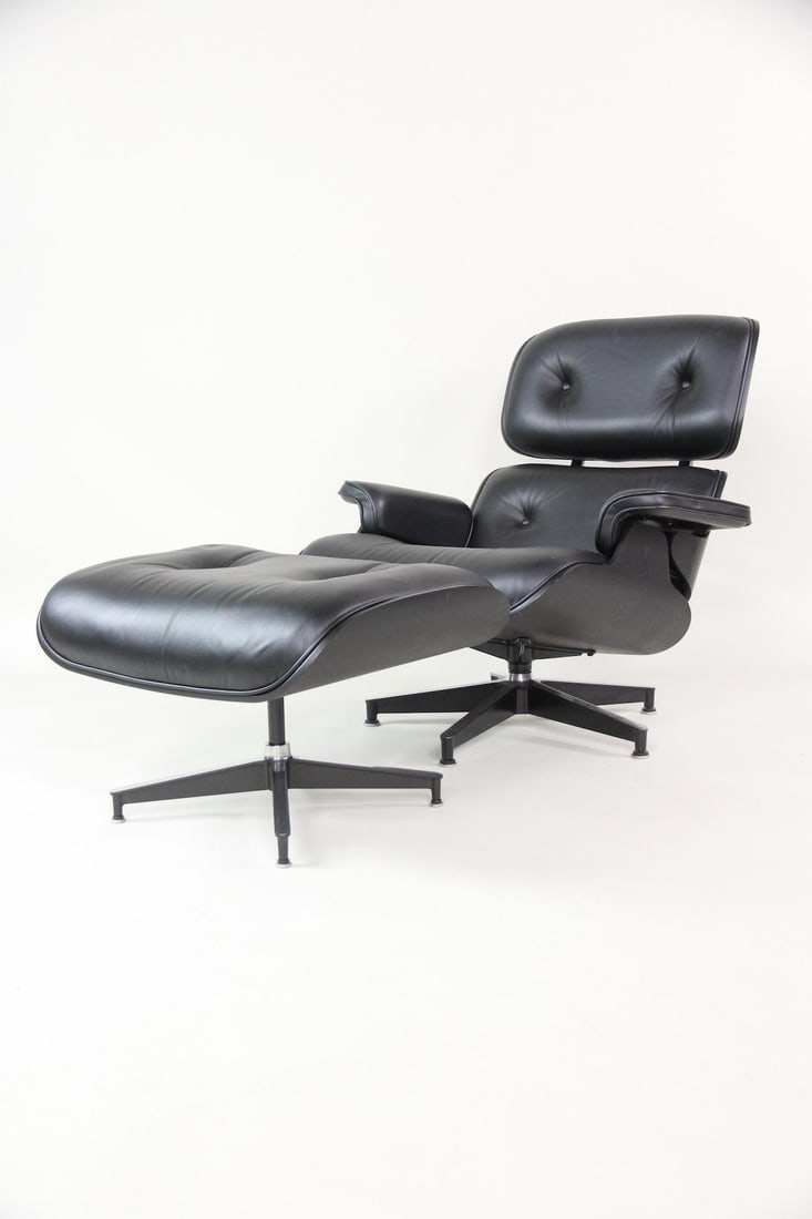 Herman Miller Eames Black on Black Leather Lounge Chair & Ottoman: Contemporary Eames Lounge Chair & Ottoman. Sleek black-on-black iconic lounge chair with matching ottoman. Made of bent plywood frame with steel base and leather cushions. Contemporary metal Herman Mi