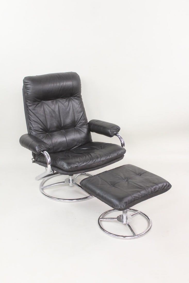 Chairworks Reclining Black Leather & Chrome Chair with Ottoman: Mid-Century Modern Reclining Black Leather & Chrome Chair with Ottoman. Features black leather upholstery, a chrome swivel base, and a side lever for reclining. Matching tufted leather ottoman. Marked