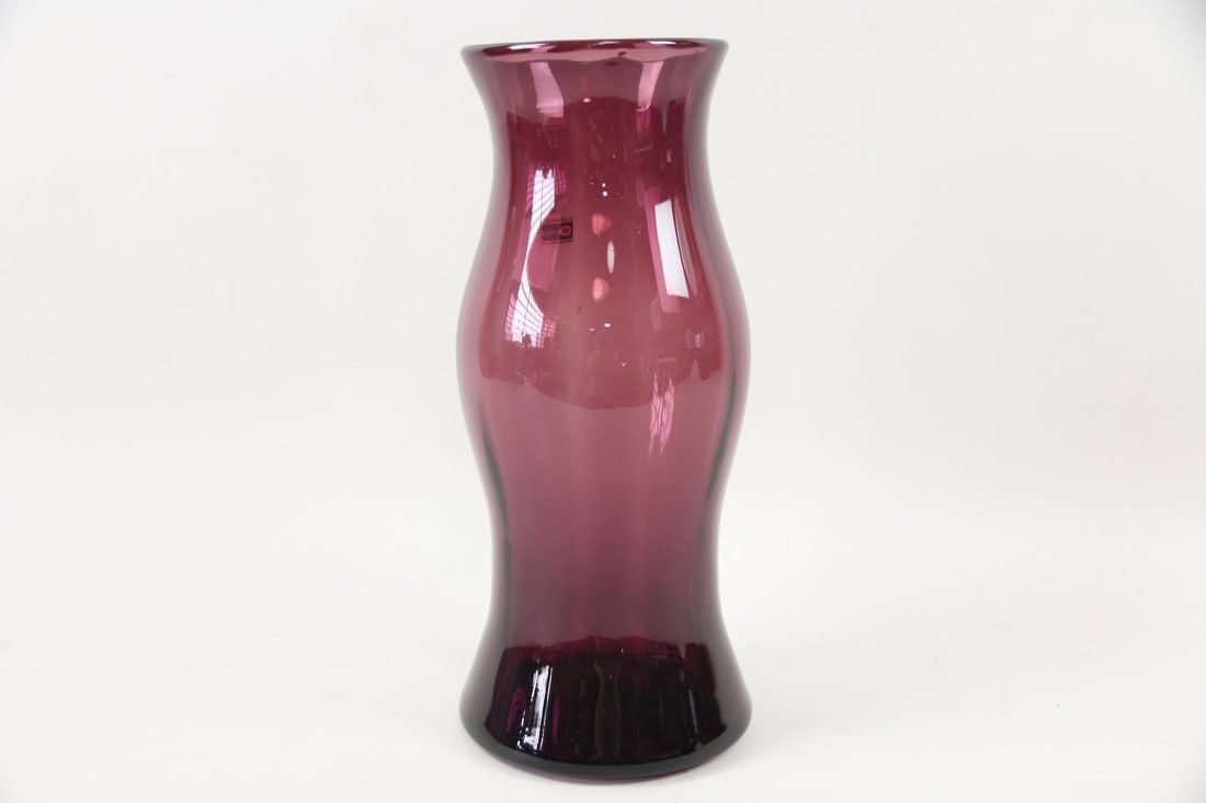 Blenko Amethyst Glass Vase: Mid-Century Modern Blenko Amethyst Glass Vase. Large purple vase with bulbous shape and flared rim, with Blenko Handmade sticker attached. Dimensions are 15 in h x 6.5 in w x 6.5 in d. Condition is go
