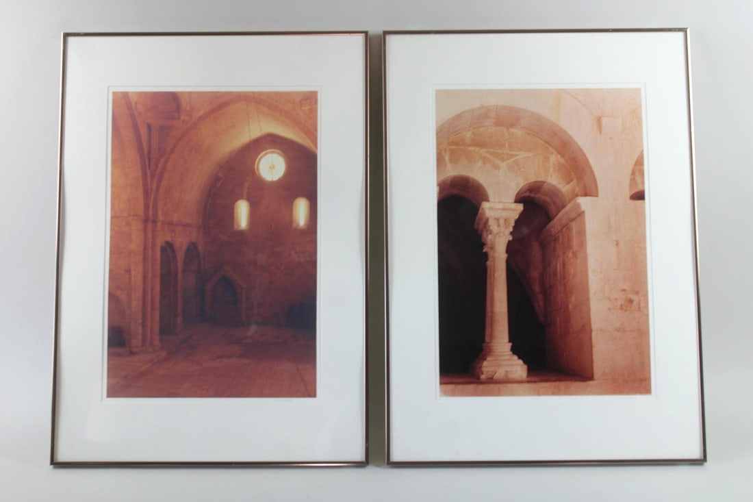 Pair of Framed Romanesque Architecture Photographs, Carol Stroll: Pair of Framed Neoclassical Romanesque Architecture Photographs, Carol Stroll. Matching pair of photos showing the interiors of monasteries or churches, featuring stone arches and columns. Signed lowe