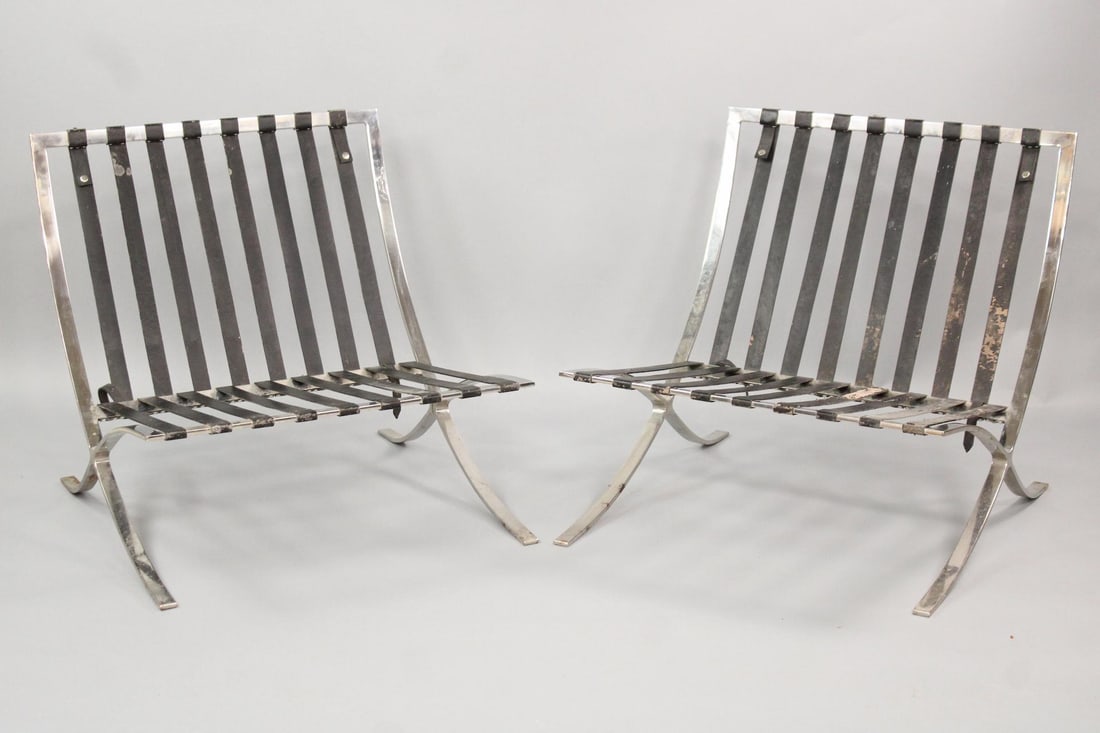 Pair of Barcelona Chair Frames, Mies van der Rohe: Pair of Barcelona Chair Frames, Mies van der Rohe. The metal frame holds leather straps which would be hidden by cushions on the angled seat. No maker's mark. Dimensions are 29.5 in h x 29.5 in w x 31