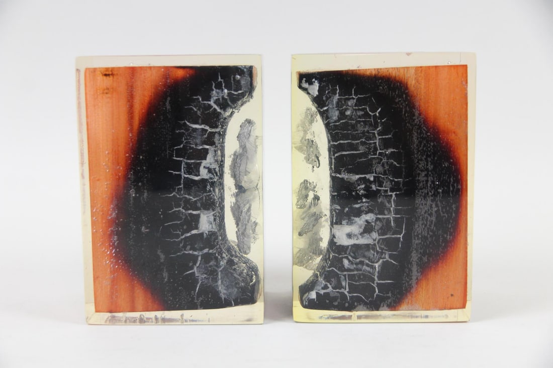 Pair of Burnt Wood & Resin Bookends: Pair of Burnt Wood & Resin Bookends. Matching pair of bookends made with actual pieces of charred wood, suspended in clear resin. Dimensions are 6.75 in h x 3.5 in w x 4.5 in d. Condition is good with