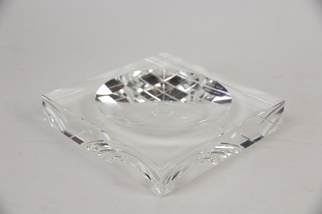Ralph Lauren Waugh Crystal Trinket Tray: Ralph Lauren Waugh Crystal Trinket Tray, Catchall or Ashtray. It is crafted from heavy, prismatic crystal and features a square silhouette with a concave, faceted center. Marked Ralph Lauren. Dimensio