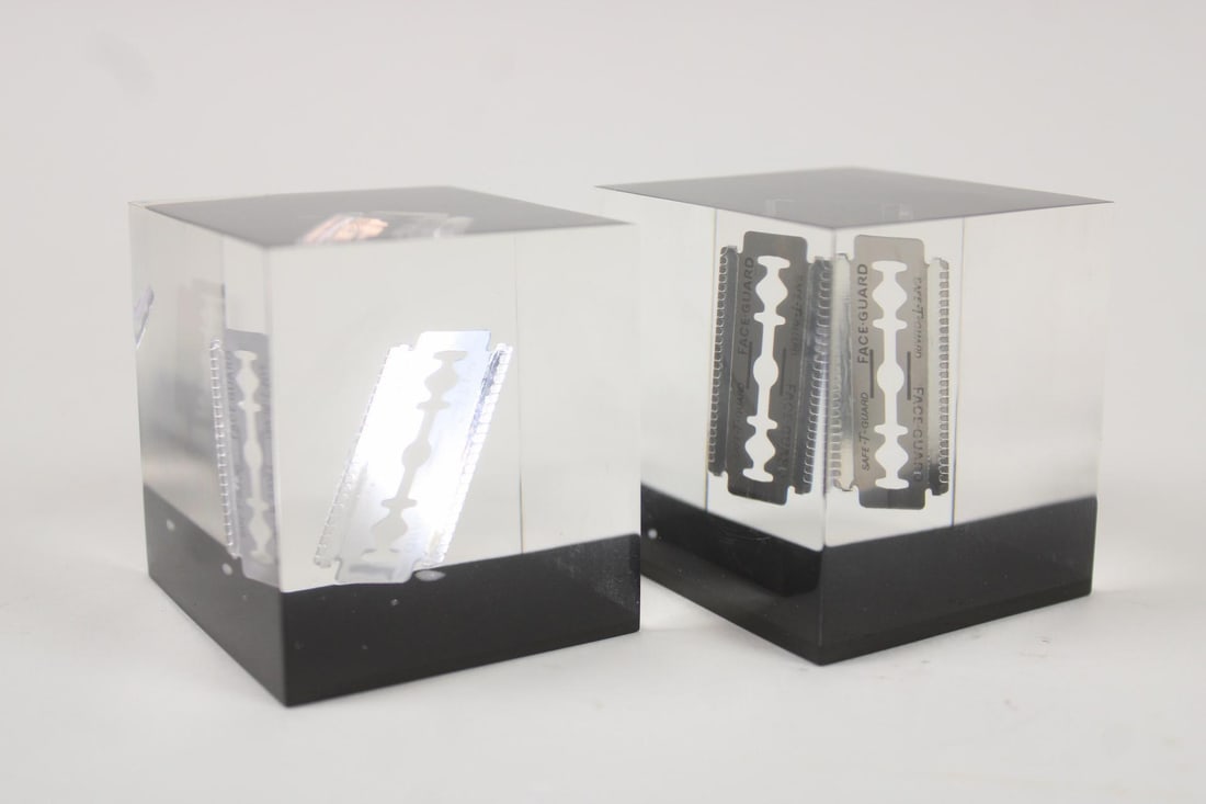 Pair of Lucite American Safety Razor Co.Paperweights: Pair of Lucite American Safety Razor Co.Paperweights. Matching pair of advertising paper weights for the American Safety Razor Company, each with razor blade suspended in lucite. Dimensions are 2.5 in