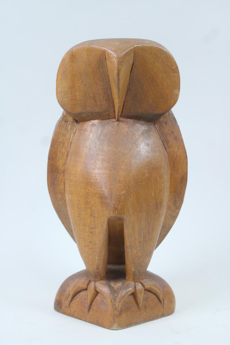 Mid-Century Modern Carved Wood Owl Sculpture: Mid-Century Modern Carved Wood Owl Sculpture. Stylized sculpture of an owl, carved from a single piece of wood. Marked India. Dimensions are 11.5 in h x 6 in w x 4.5 in d. Condition is good with some