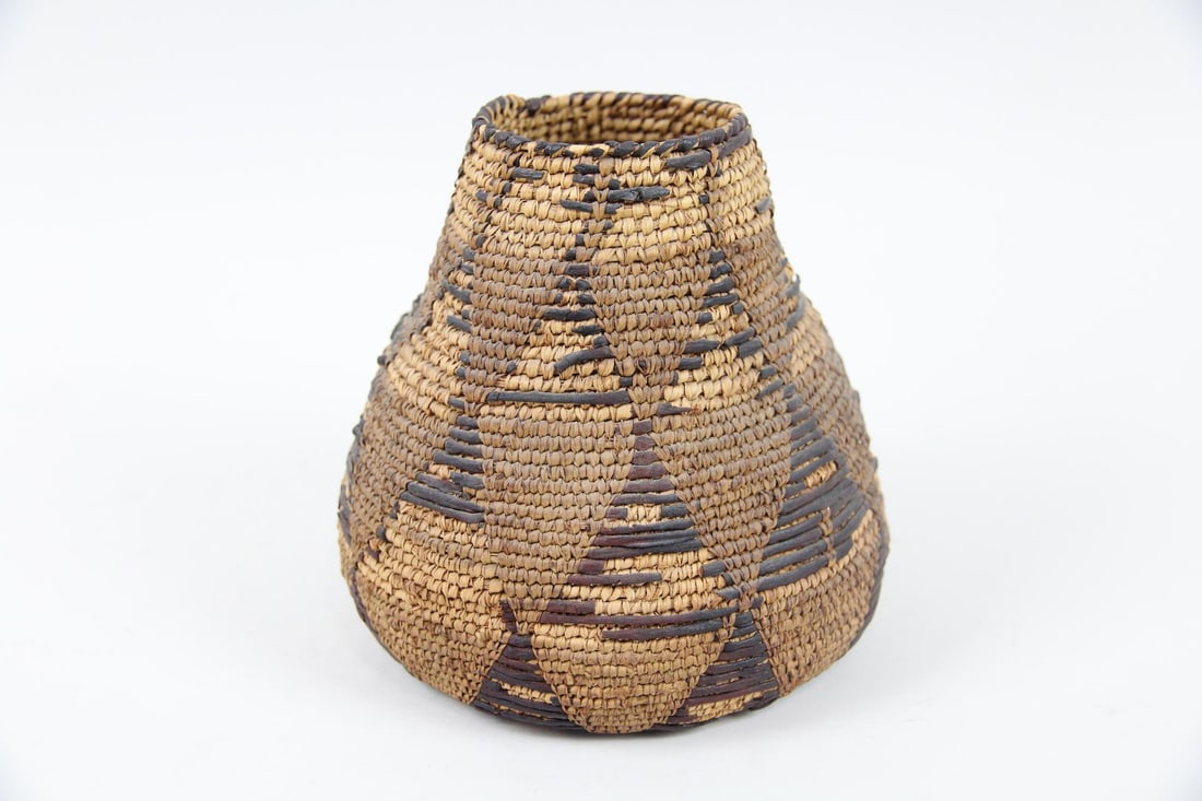 Native American Coiled Basket with Triangle Motif: Native American Coiled Grass Basket with Triangle Motif. Possibly from the Tohono O'odham people of Arizona and Mexico. Dimensions are 5.75 in h x 5.5 in w x 5.5 in d. Condition is good with some mino
