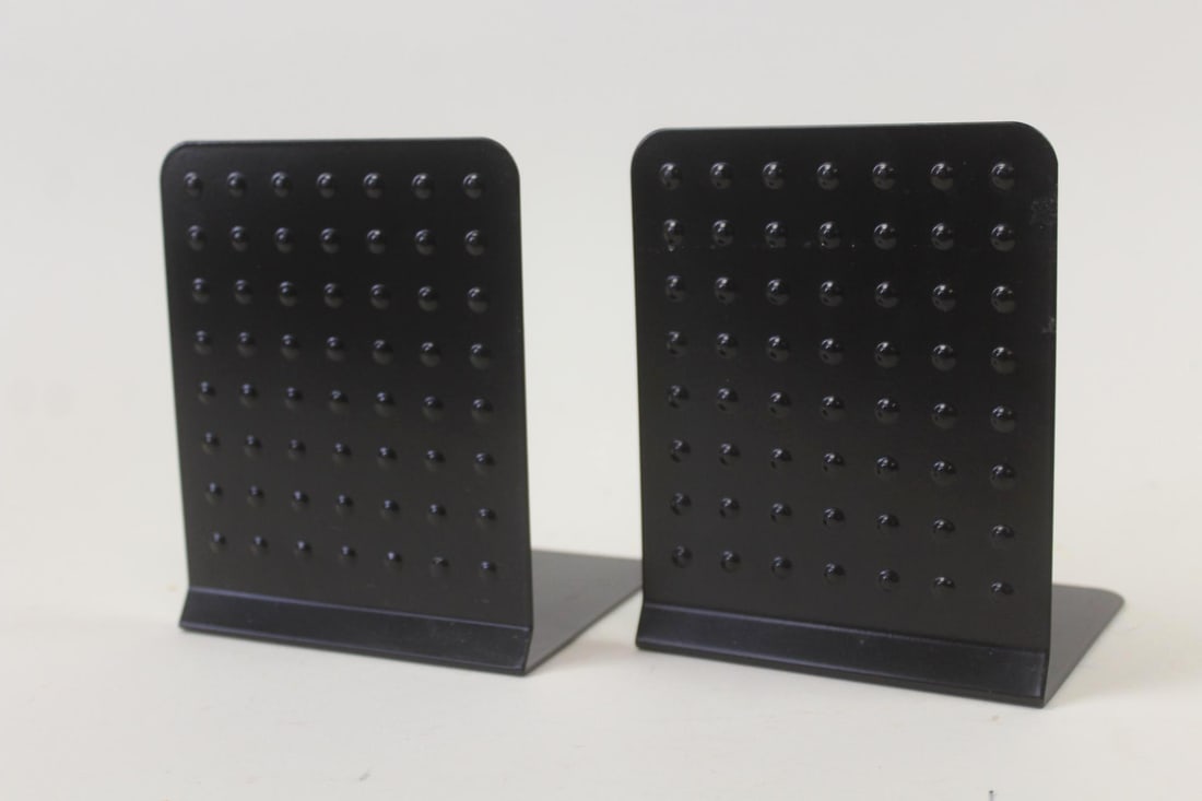 Pair of Black Pop Art Metal Bookends, Bumpy Dot Grid: Pair of Industrial Metal Bookends, Embossed Dots. Matching bookends made of black painted metal with a textural dot patterned surface. Dimensions are 6.25 in h x 5 in w x 4.75 in d. Condition is good.