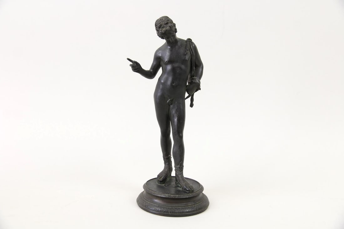 Bronze Greek Mythological Statue of Narcissus, Nude Man Sculpture: Neoclassical Bronze Mythological Statue of Narcissus. A replica of the original ancient Roman statue, likely a souvenir. With a dark patina. Dimensions are 11.5 in h x 5 in w x 4.25 in d. Condition is