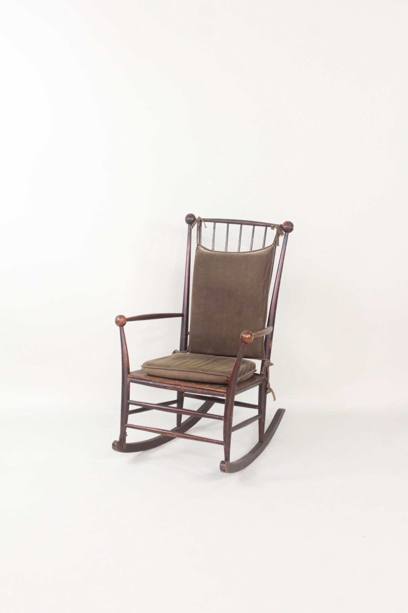 Stick & Ball Rocking Chair, Hunzinger: Stick & Ball Rocking Chair, George Hunzinger Style. This chair comes as we found it with tie down velvet cushions. Simplicity in design. Dimensions are 38 in h x 24.25 in w x 30 in d. Seat rise is 16