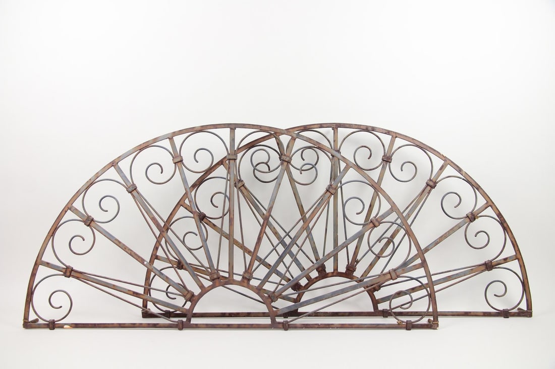 Pair of Wrought Iron Transom Grills, Architectural Elements: Pair of Wrought Iron Transom Grills, Architectural Elements. Matching pair of large wrought iron arched transom window grills, with afan-shaped design with radiating bars and intricate scrollwork. Dim