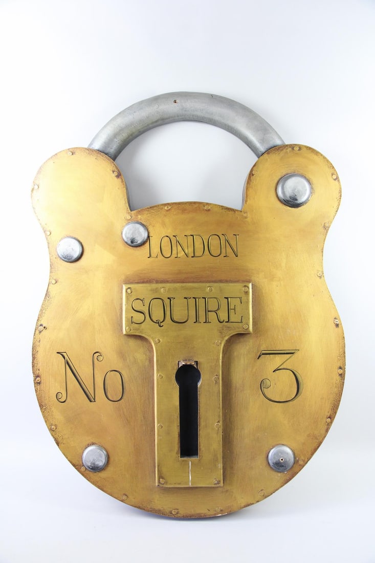 Large Painted Wood Padlock Trade Sign: Large Painted Wood Padlock Sculpture or Trade Sign. Large-scale decorative replica of a Squire "Old English" padlock. Dimensions are 43 in h x 31.5 in w x 3.5 in d. Condition is good with minor wear a