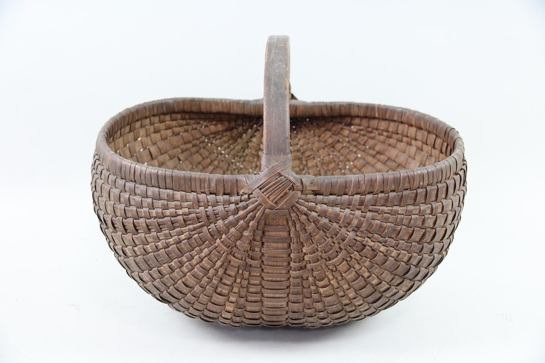 Primitive Buttocks Gathering Basket: Primitive Wicker Buttocks Gathering Basket. A beautiful gathering basket with a "buttocks" or "melon" shape. Skillfully woven with wood splints, likely ash or oak. Dimensions are 12.5 in h x 15 in w x