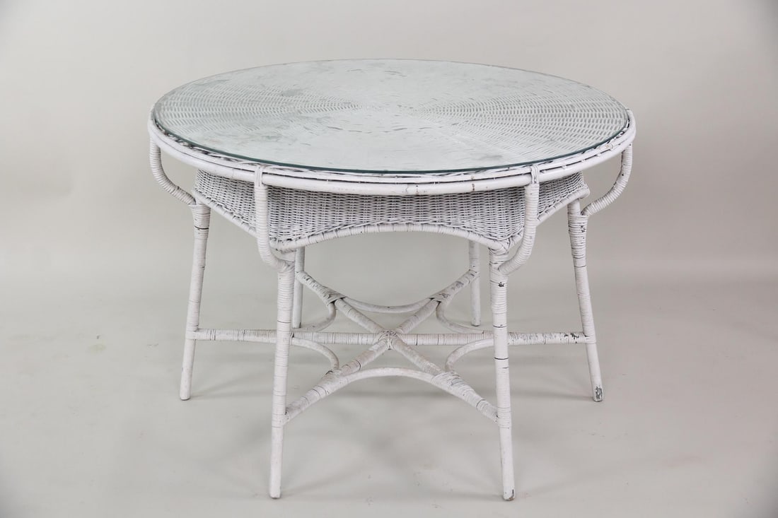 Interesting Round Wicker Table: Interesting Round Wicker Table. It comes with a removable glass top. It has an almost spider web designed shape to the base. Dimensions are 29 in h x 41 in w x 41 in d. Condition is good. Please call