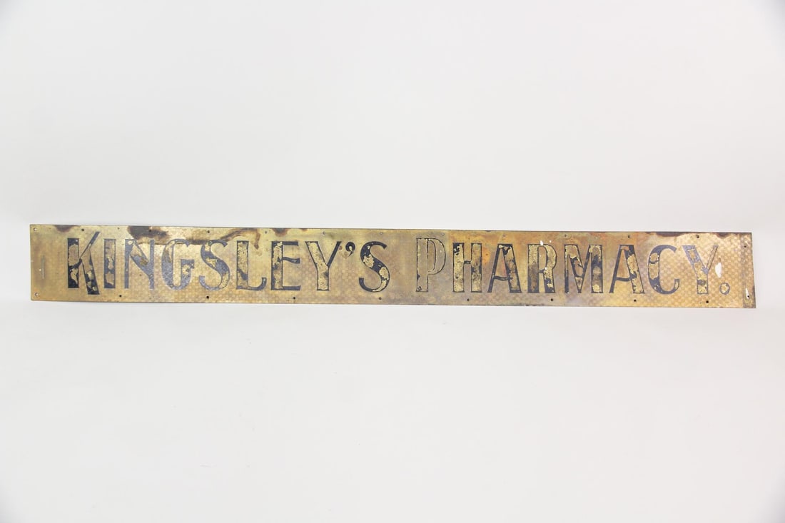 Brass Kingsley's Pharmacy Apothecary Trade Sign: Brass & Gilt Kingsley's Pharmacy Apothecary Trade Sign. A fantastic trade sign for a pharmacy storefront, with beautifully patinated brass surface and worn black painted lettering. Dimensions are 8 in