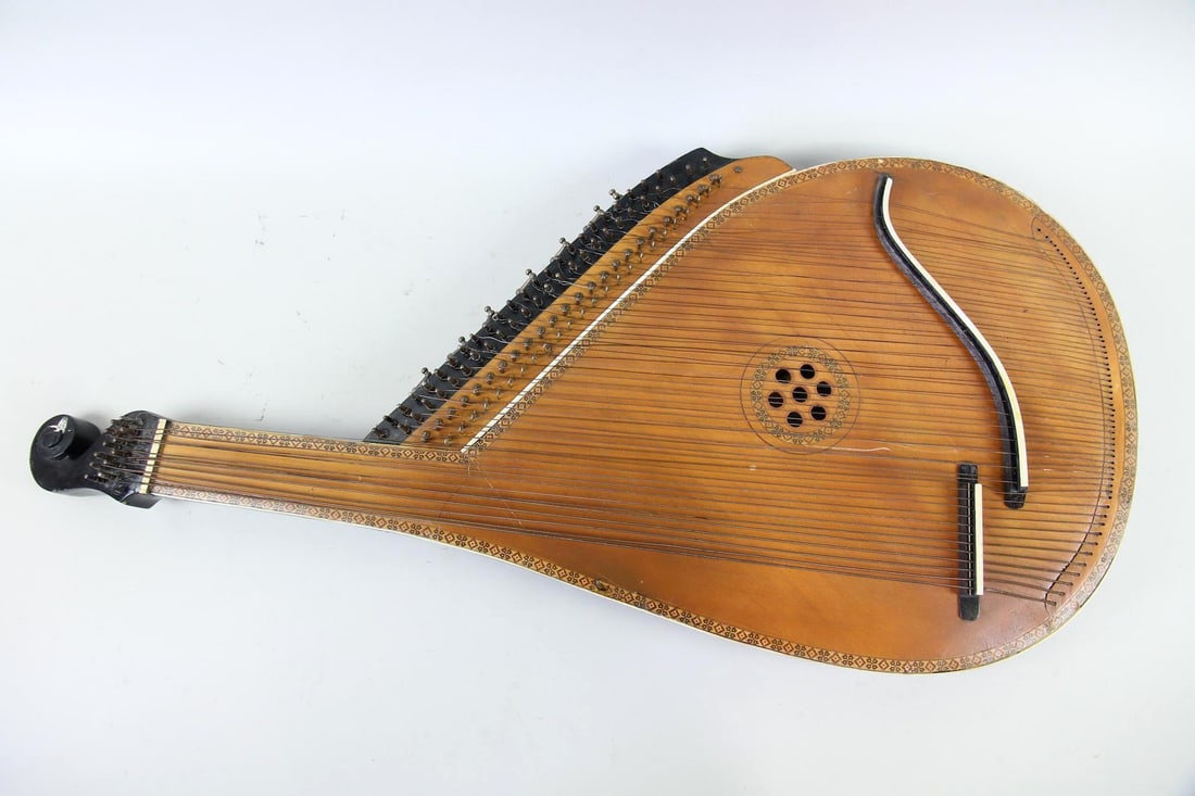Ukranian Bandura, Folk Instrument with Inlaid Wood: Ukranian Bandura, Folk Instrument with Inlaid Wood. A full-sized bandura, this folk instrument is made of wood with intricate inlay to the edges. Dimensions are 43 in h x 20 in w x 3.5 in d. Condition
