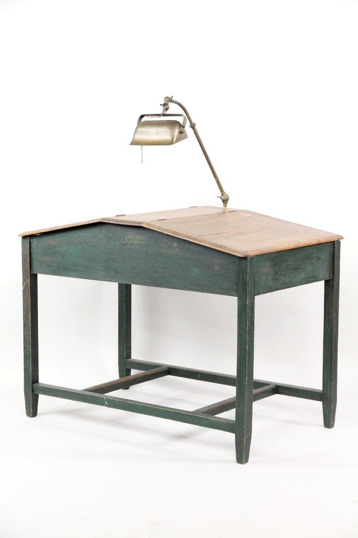Double Sided Green Painted Partners Desk with Lamp: School House Partner's Desk with Metal Lamp, Green Paint. This is a double-sided partners desk, with each side having a slanted top & hinged compartment, and a shared library lamp. Made of wood with