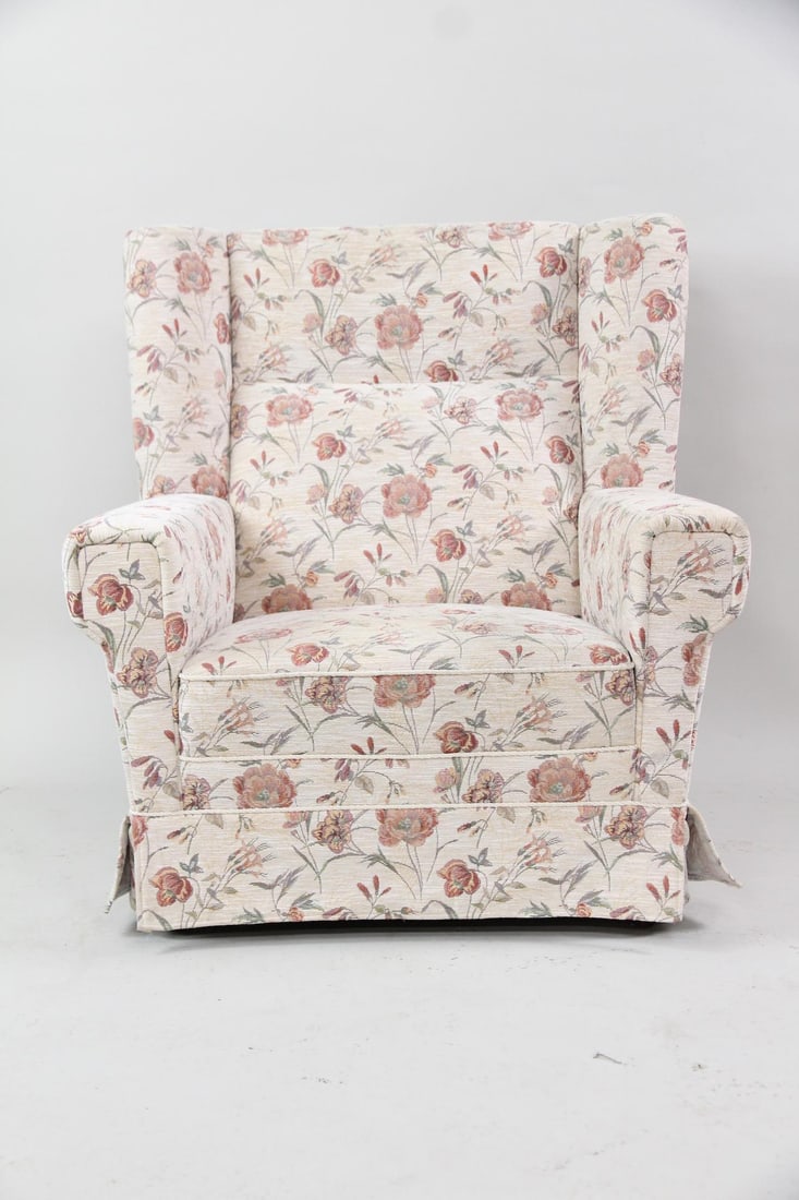 Danish Modern Floral Upholstered Wingback Armchair: Danish Modern Floral Upholstered Wingback Armchair. Wingback armchair from Denmark, upholstered in a cream or beige textured fabric with a pink and green floral pattern. Dimensions are 37.75 in h x 35