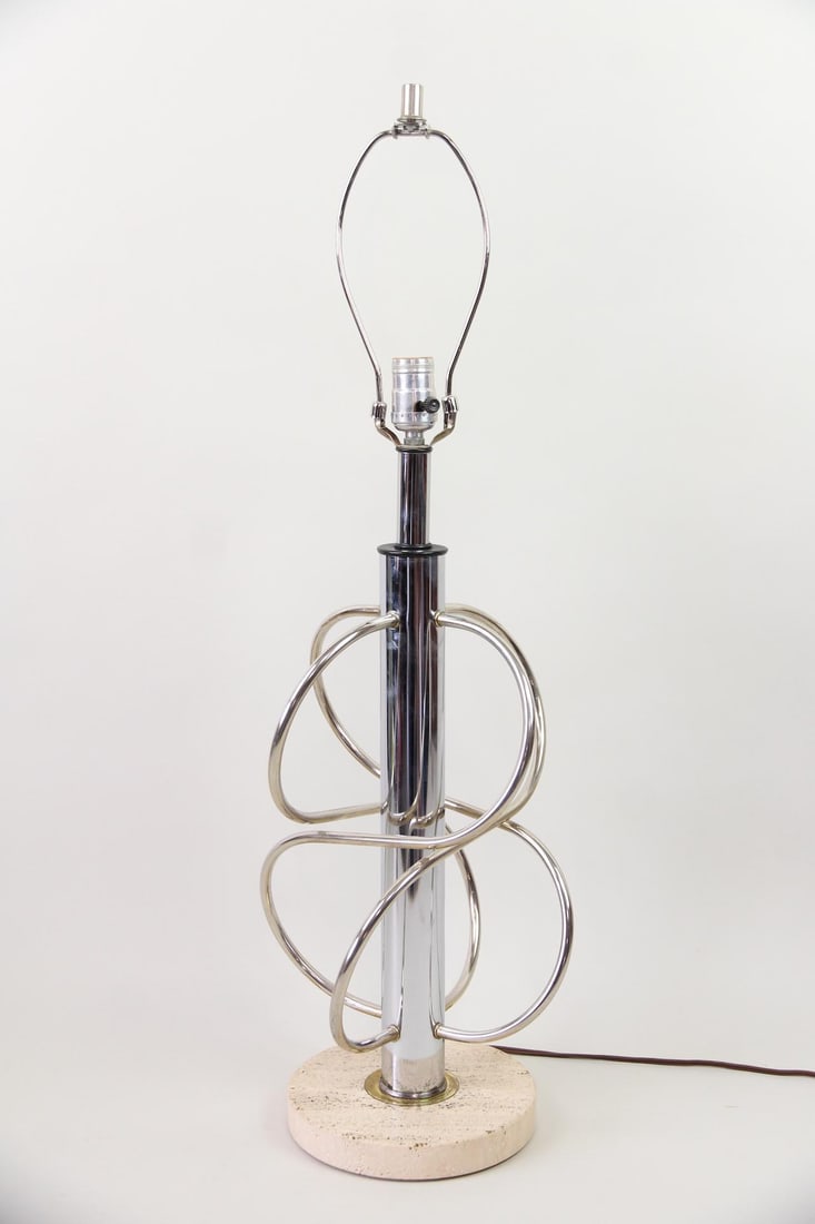 Italian Atomic Mixed Metal Lamp with Travertine Base: Italian Atomic Mixed Metal Lamp with Travertine Base. Sculptural lamp in chrome with brass accents standing on a travertine base. Marked Made in Italy. Dimensions are 31.75 in h x 10 in w x 10 in d.