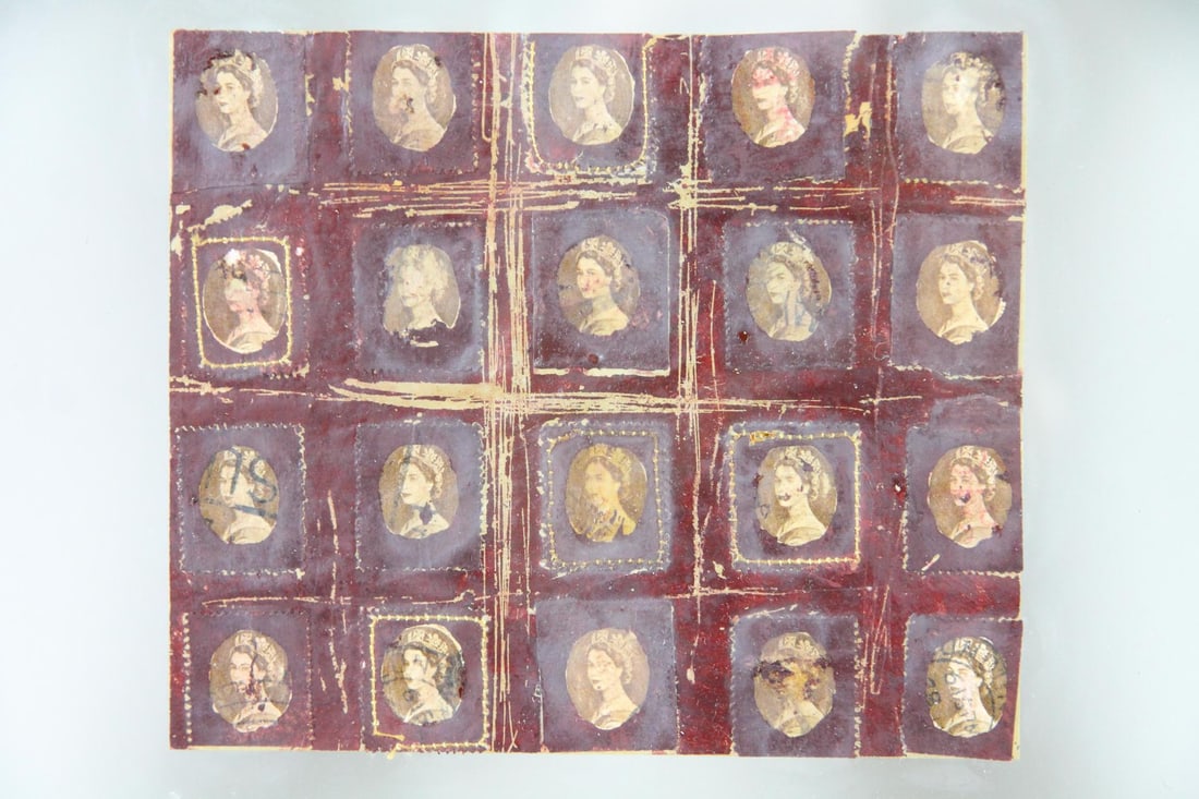 Queen Elizabeth Stamps Mixed Media Collage: Mixed Media Collage using Queen Elizabeth Stamps. Contemporary artwork using a grid of 20 canceled stamps featuring Queen Elizabeth, with embroidered details around each image. Floating in a gilt